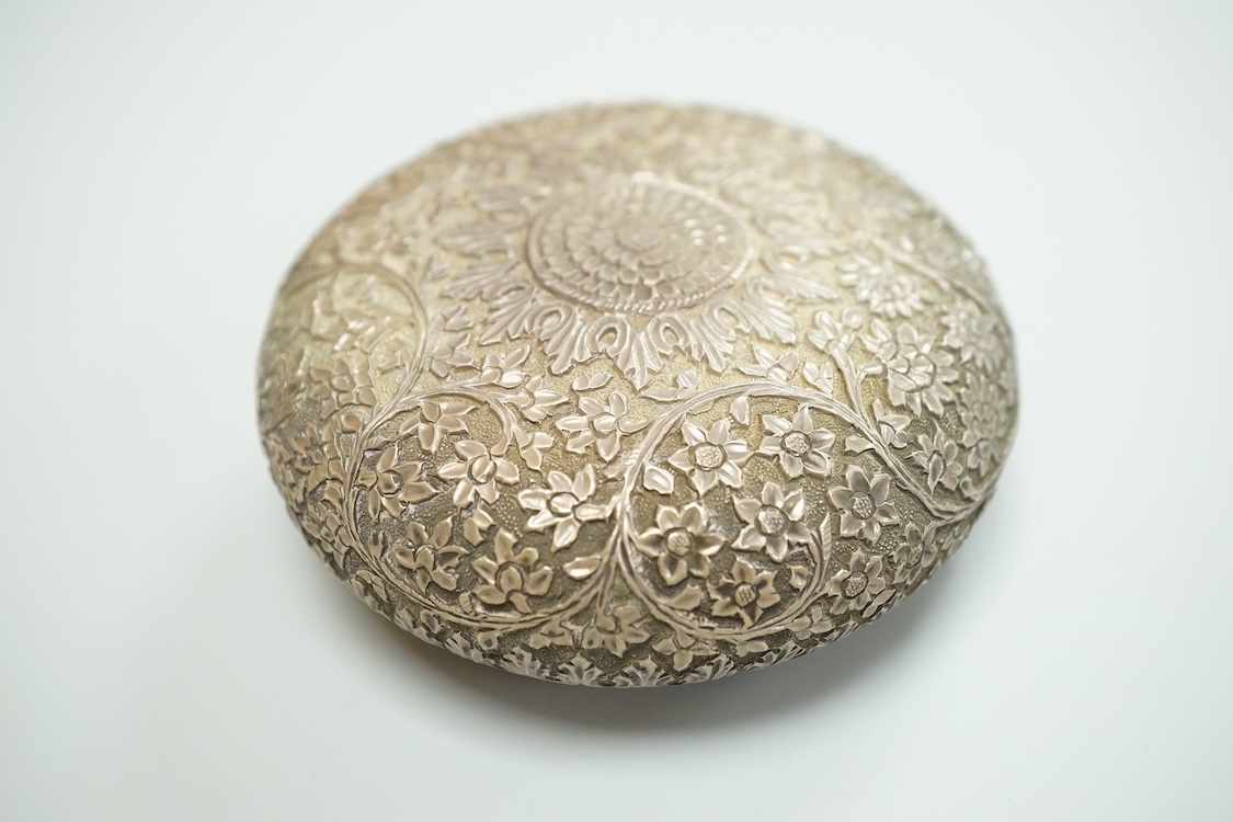 A Thai white metal tobacco box, embossed with foliage, diameter 72mm together with a similar dish.